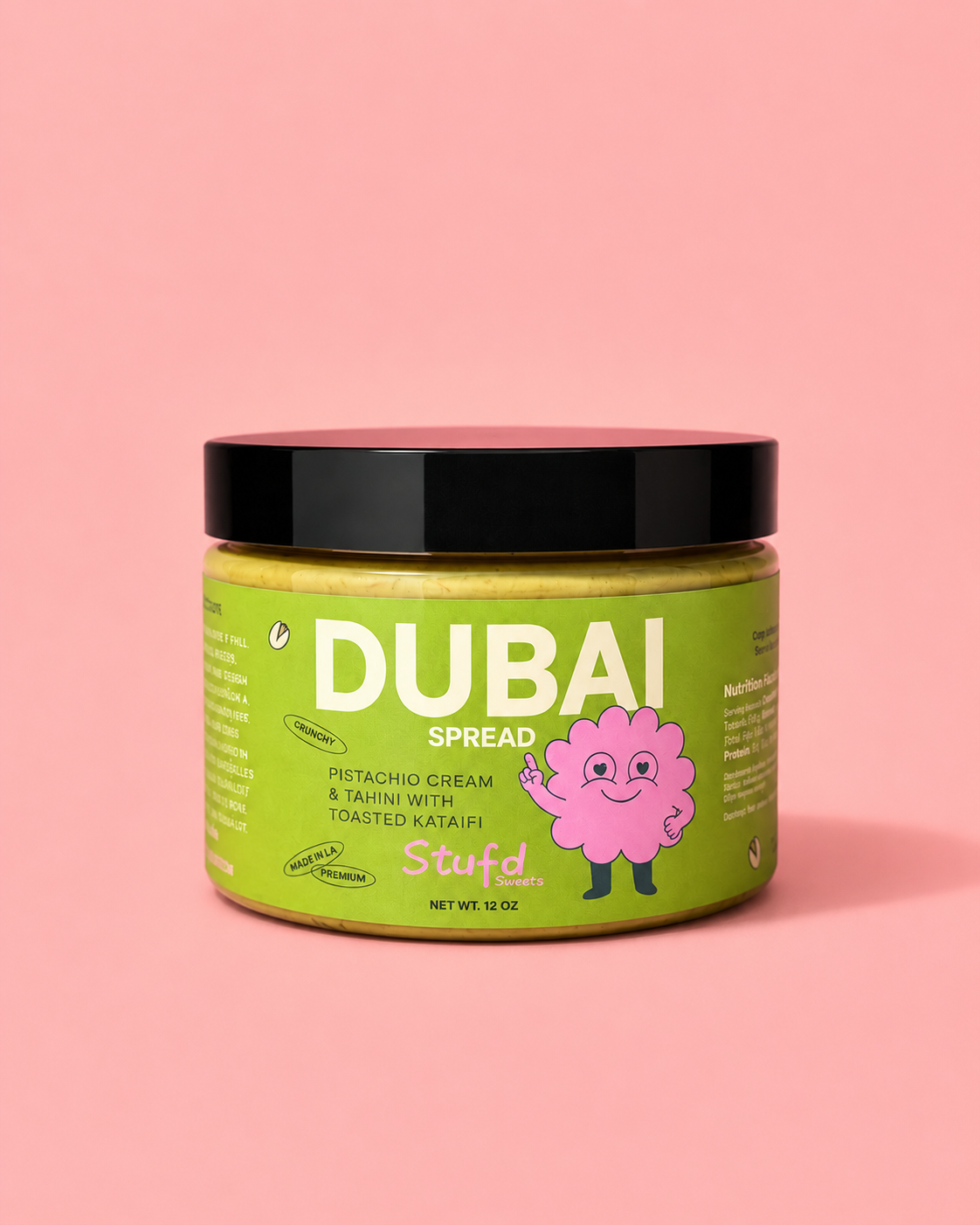 A 16 oz jar of Spread Pistachio Cream on a solid pink background. 